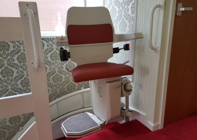 Halton-Sapphire-Curved-Stairlift-Curve-Chairlift in Red Upholstery Swiveled